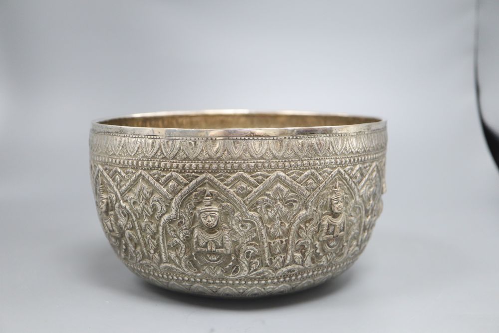 A Burmese silver bowl, c.1900, with repousse Buddha panels, 14.3oz., diameter 21cm